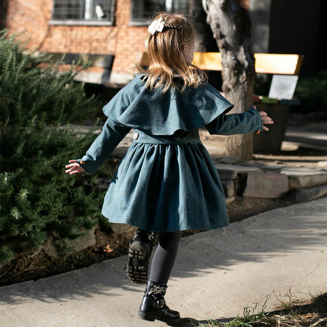 Girl wearing Anaario Diana Capelet Coat, teal wool-look coat with cape collar and tie waist