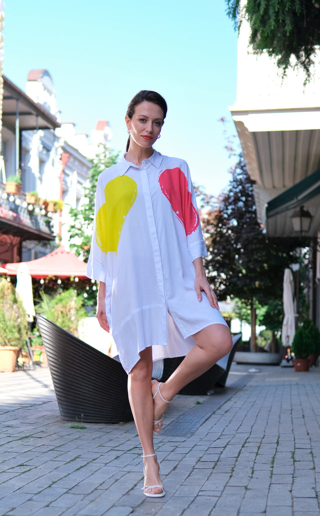 Woman wearing Anaario K-Pop Krush Shirt Dress, white long shirt dress with yellow and coral paint-splash graphic
