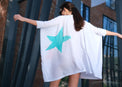 Woman wearing Anaario K Pop Krush Shirt Dress, white oversized shirt dress with teal and orange star graphic