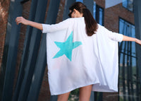 Woman wearing Anaario K Pop Krush Shirt Dress, white oversized shirt dress with teal and orange star graphic