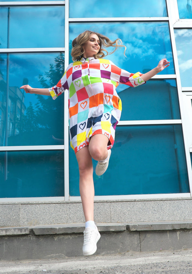 Woman wearing Anaario K-Pop Krush Shirt Dress, multicolor checkered oversized shirt dress with heart print