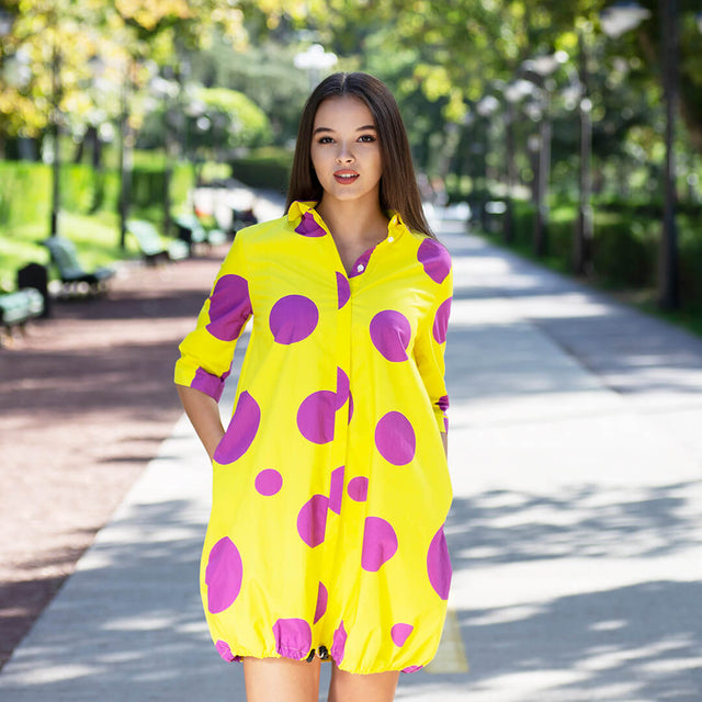 Woman wearing Anaario Katy Perry Bubble Hem Dress, yellow dress with purple polka dot print and bubble hem