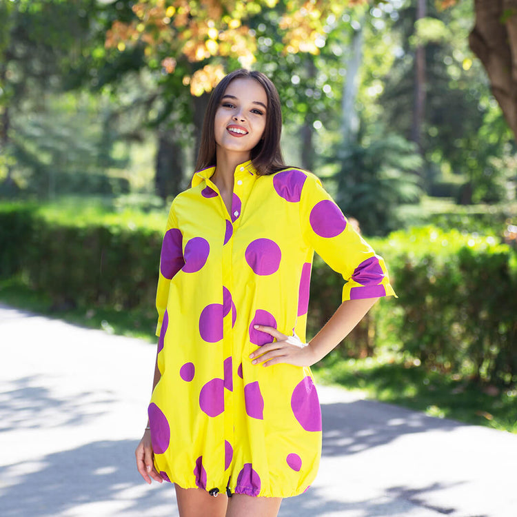 Woman wearing Anaario Katy Perry Bubble Hem Dress, yellow dress with purple polka dot print and bubble hem