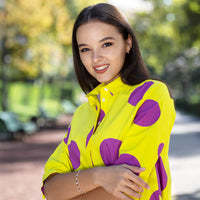 Woman wearing Anaario Katy Perry Bubble Hem Dress, yellow dress with purple polka dot print and bubble hem