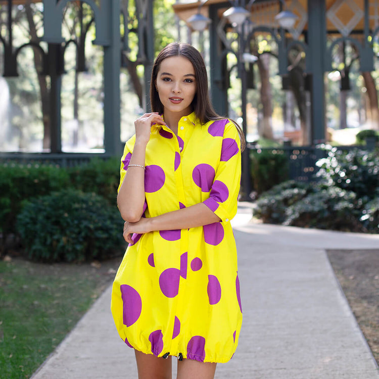 Woman wearing Anaario Katy Perry Bubble Hem Dress, yellow dress with purple polka dot print and bubble hem