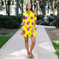 Woman wearing Anaario Katy Perry Bubble Hem Dress, yellow dress with purple polka dot print and bubble hem