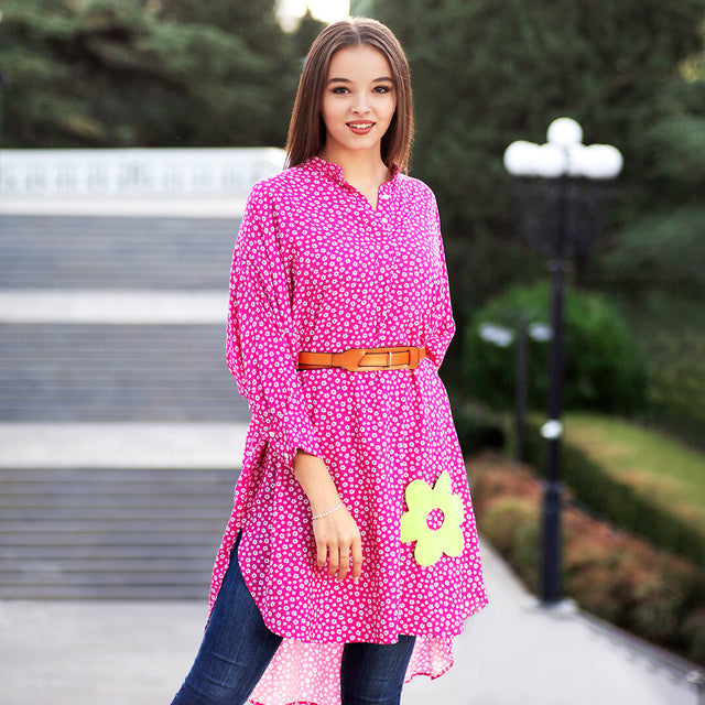 Woman wearing Anaario La Belle Tunic, pink floral print tunic with yellow flower patch and belted waist