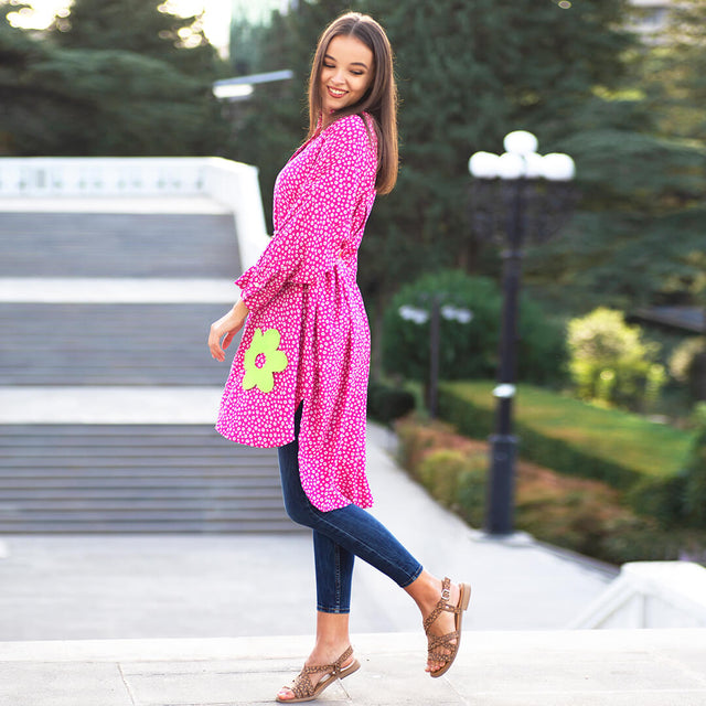 Woman wearing Anaario La Belle Tunic, pink floral print tunic with yellow flower patch and belted waist