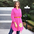 Woman wearing Anaario La Belle Tunic, pink floral print tunic with yellow flower patch and belted waist
