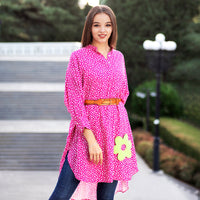 Woman wearing Anaario La Belle Tunic, pink floral print tunic with yellow flower patch and belted waist