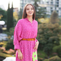 Woman wearing Anaario La Belle Tunic, pink floral print tunic with yellow flower patch and belted waist