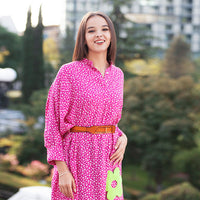 Woman wearing Anaario La Belle Tunic, pink floral print tunic with yellow flower patch and belted waist