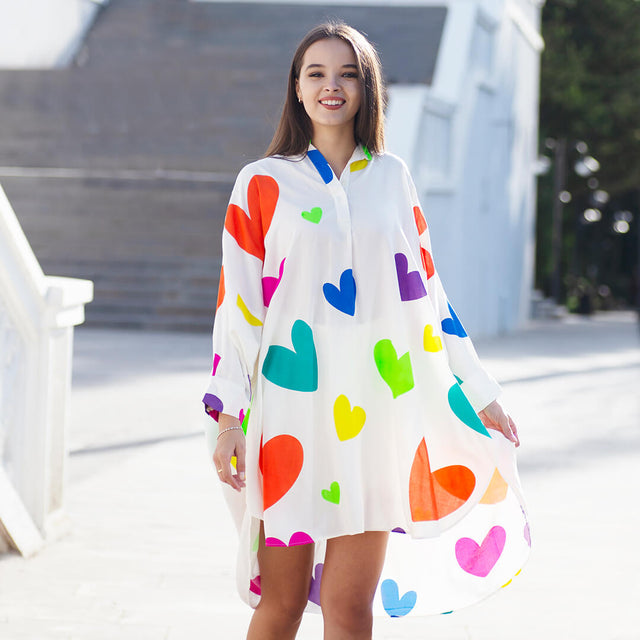 Woman wearing Anaario La Belle Tunic, white oversized tunic with multicolor heart print