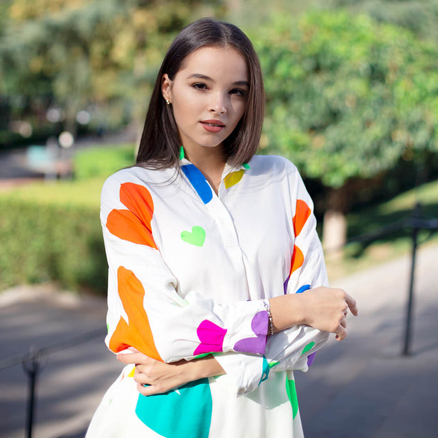 Woman wearing Anaario La Belle Tunic, white oversized tunic with multicolor heart print