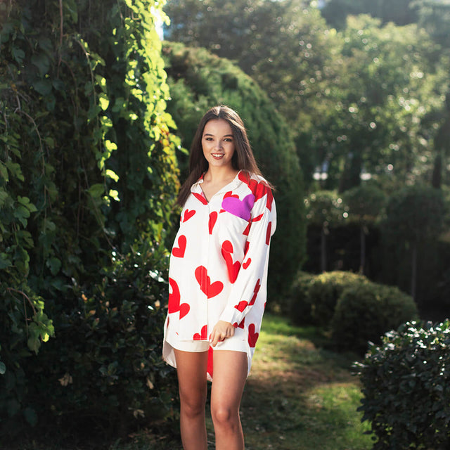 Woman wearing Anaario Love Island Shirt, white oversized shirt with red heart print