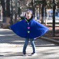 Girl wearing Anaario Mulan Cape Coat, royal blue hooded cape coat with heart button closures
