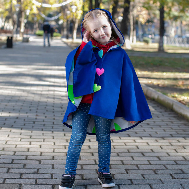 Girl wearing Anaario Mulan Cape Coat, royal blue hooded cape coat with heart button closures