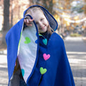 Girl wearing Anaario Mulan Cape Coat, royal blue hooded cape coat with heart button closures