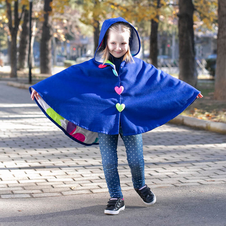 Girl wearing Anaario Mulan Cape Coat, royal blue hooded cape coat with heart button closures
