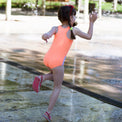 Girl wearing Anaario Orange Purple Star One Piece swimsuit, orange and lilac colorblock one-piece swimsuit with star-point seam design