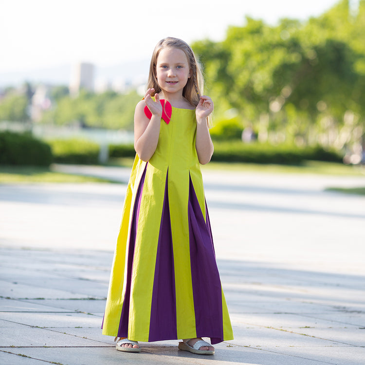 Girl wearing Anaario Pixie Dixie colorblock maxi dress in lime green, purple, and orange