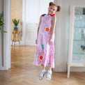 Girl wearing Anaario Sail Away maxi dress in white with pink dashed line print and colorful star appliques