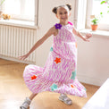 Girl wearing Anaario Sail Away maxi dress in white with pink dashed line print and colorful star appliques