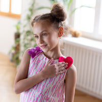 Girl wearing Anaario Sail Away maxi dress in white with pink dashed line print and colorful star appliques