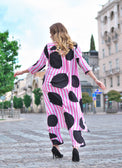 Person wearing Anaario Santorini Co-ord Set, pink and white stripe top and pants with black heart print