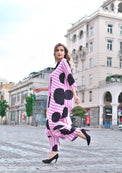 Person wearing Anaario Santorini Co-ord Set, pink and white stripe top and pants with black heart print