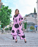 Person wearing Anaario Santorini Co-ord Set, pink and white stripe top and pants with black heart print