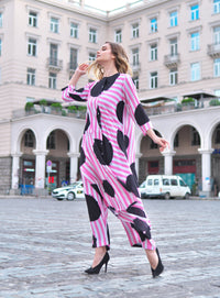 Person wearing Anaario Santorini Co-ord Set, pink and white stripe top and pants with black heart print