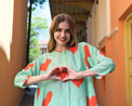 Person wearing Anaario Santorini Co-ord Set, mint green oversized top and pants with orange heart print