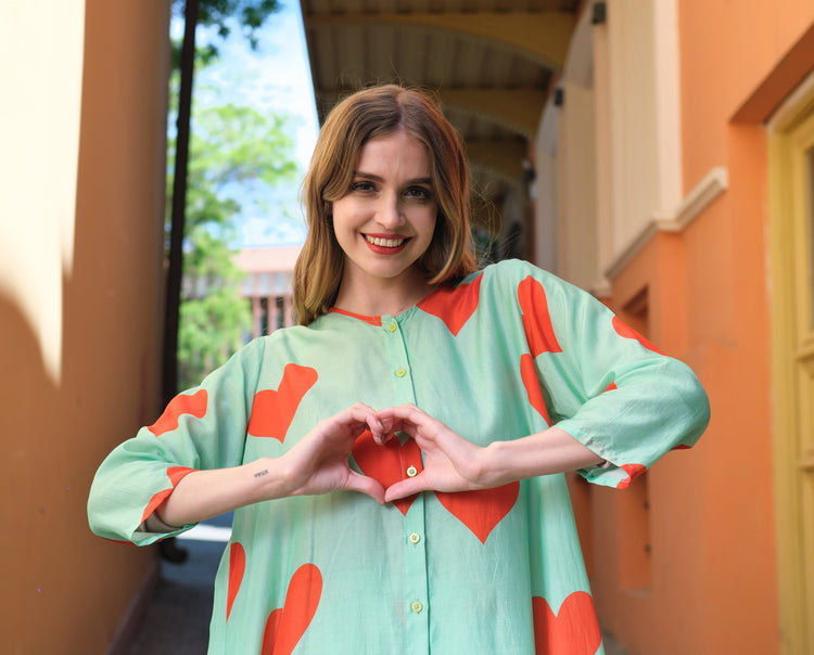 Person wearing Anaario Santorini Co-ord Set, mint green oversized top and pants with orange heart print
