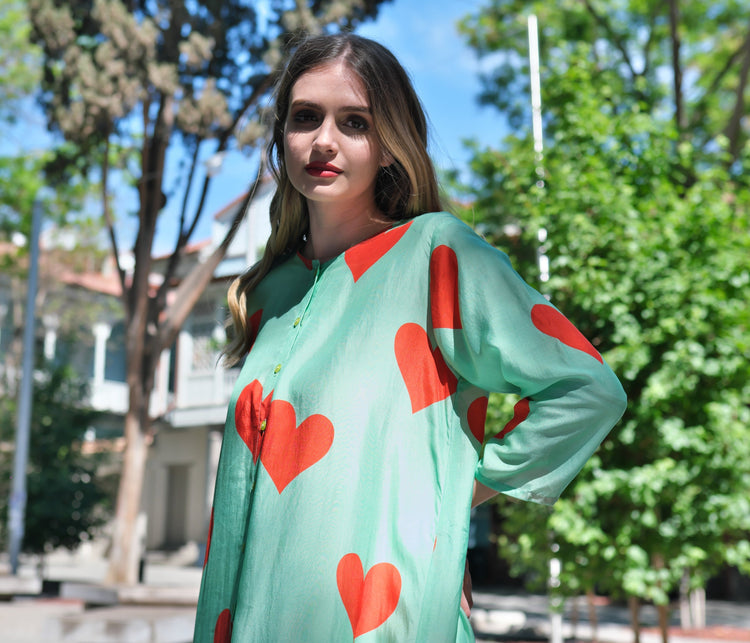 Person wearing Anaario Santorini Co-ord Set, mint green oversized top and pants with orange heart print