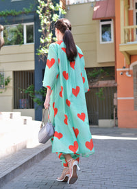 Person wearing Anaario Santorini Co-ord Set, mint green oversized top and pants with orange heart print