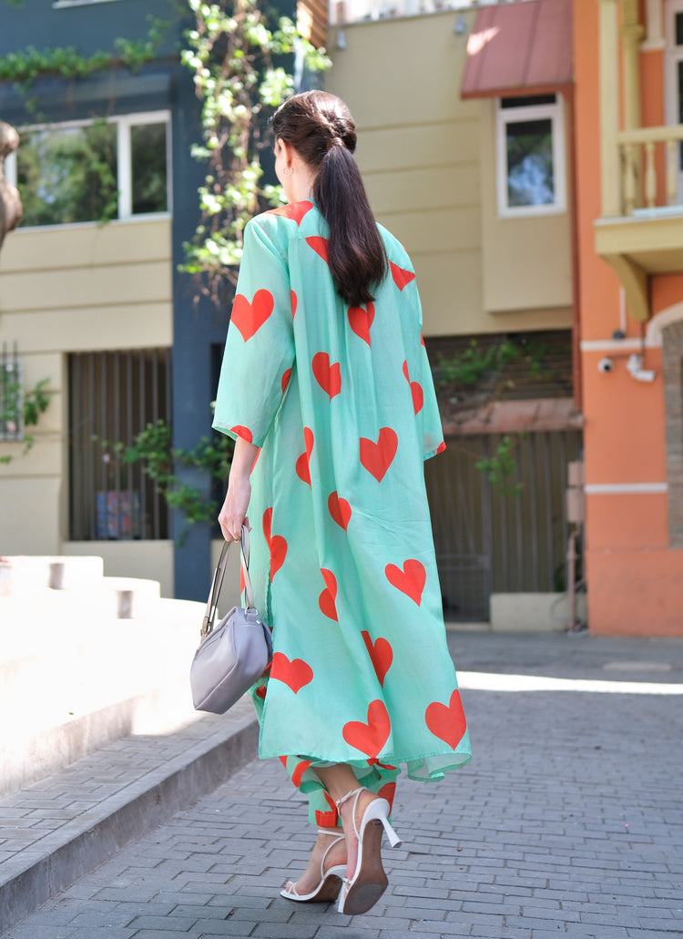Person wearing Anaario Santorini Co-ord Set, mint green oversized top and pants with orange heart print