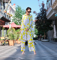 Person wearing Anaario Sweet Serenade Co-ord Set, yellow and white abstract print longline shirt with matching pants