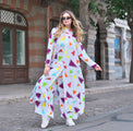 Person wearing Anaario Wild Wanderer Co-ord Set, white maxi duster with multicolor triangle print over matching pants