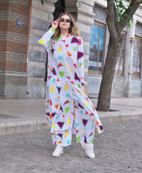 Person wearing Anaario Wild Wanderer Co-ord Set, white maxi duster with multicolor triangle print over matching pants