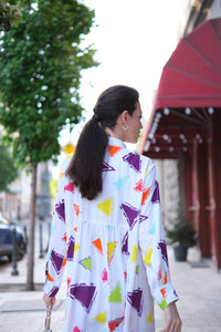 Person wearing Anaario Wild Wanderer Co-ord Set, white maxi duster with multicolor triangle print over matching pants