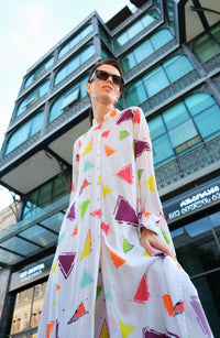 Person wearing Anaario Wild Wanderer Co-ord Set, white maxi duster with multicolor triangle print over matching pants