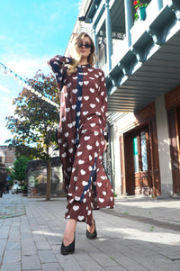 Person wearing Anaario Wild Wanderer Co-ord Set, brown maxi duster with white heart print over matching pants