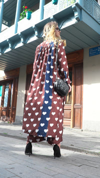 Person wearing Anaario Wild Wanderer Co-ord Set, brown maxi duster with white heart print over matching pants