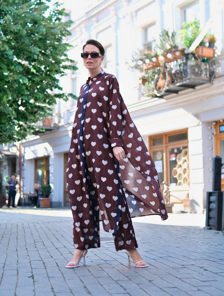Person wearing Anaario Wild Wanderer Co-ord Set, brown maxi duster with white heart print over matching pants